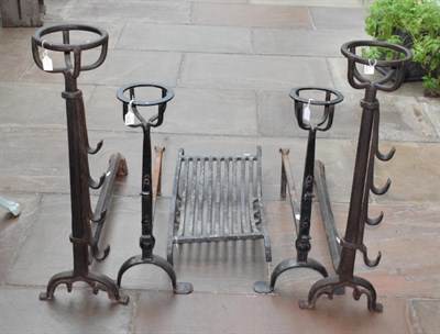 Lot 1302 - A Pair of Wrought Iron Andirons, in 16th century style, with basket finials on panelled stems...