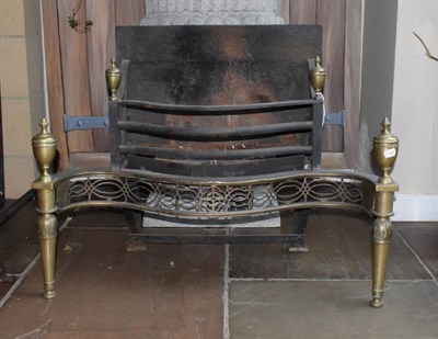 Lot 1303 - A George III Style Brass and Steel Fire Basket, of serpentine form with urn shaped finials, pierced