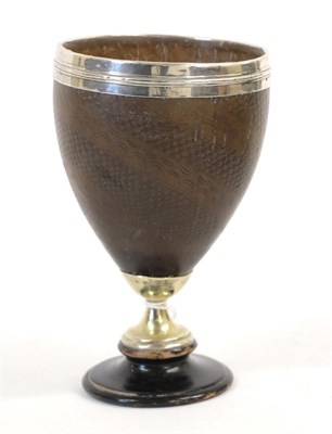 Lot 1328 - An Early 19th Century Coconut Cup, lightly carved with wrythen bands of chequering, with silver...