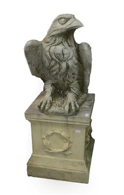 Lot 1332 - A Cast Stone Figure of an Heraldic Eagle, perched on a rocky base, on a square section column...