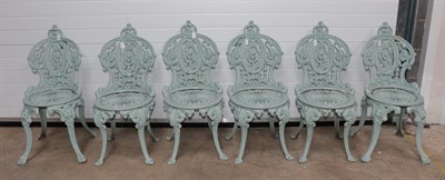 Lot 1337 - A Set of Four Victorian Cast Iron Garden Chairs, the cartouche shaped backs with foliate...