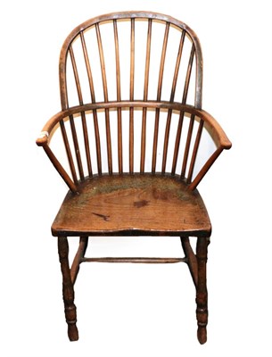 Lot 1347 - A Mid 19th Century Ash Windsor Armchair, with double spindle back support and curved arms above...