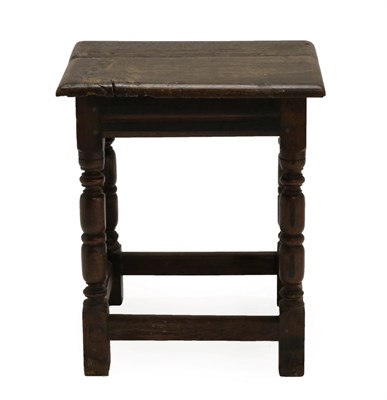 Lot 1354 - An 18th Century Oak Joint Stool, with moulded apron, on turned and block legs joined by a...