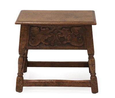 Lot 1357 - A Joined Oak Box Stool, the hinged lid above a relief carved panel of two dragons, on turned...