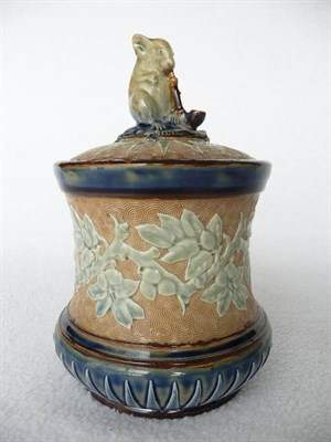 Lot 1420 - A Doulton Lambeth Stoneware Tobacco Jar, with applied moulded fruiting branches on a buff...