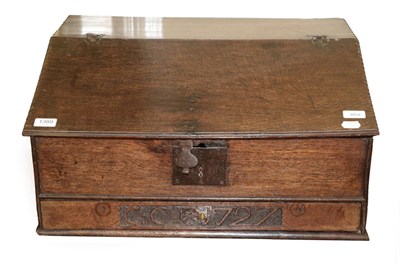 Lot 1389 - An 18th Century Carved Oak Bible Box, dated and initialled 1727 CC, the hinged lid with chip carved