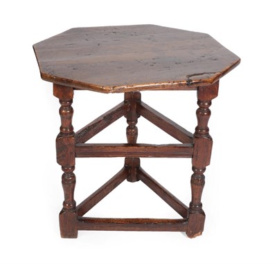 Lot 1392 - A Joined Oak Octagonal Cricket Table, the pegged top on baluster turned supports joined by...