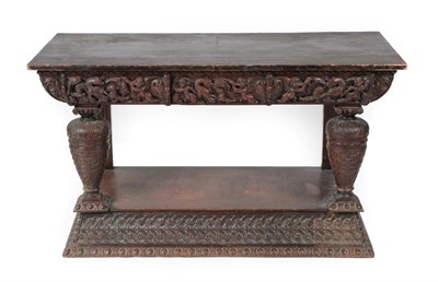 Lot 1401 - A Carved Oak Side Table, the later top above a relief carved frieze of dogs, serpents and...