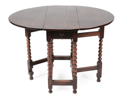 Lot 1402 - ^ A Late 17th Century Oak Four-Seater Dropleaf Dining Table, with two hinged leaves to form an...