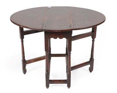 Lot 1403 - ^ An Early 18th Century Gateleg Table, of attractive proportions, the pegged top above spindle...