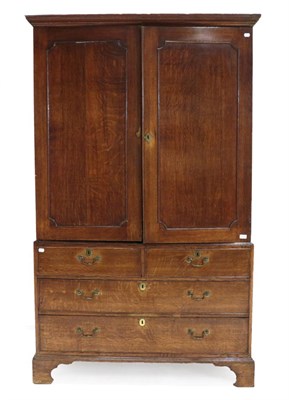 Lot 1406 - ^ A Late George III Oak Linen Press, early 19th century, the moulded cornice above two moulded...