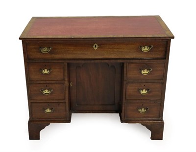 Lot 1412 - A George III Mahogany Kneehole Desk, circa 1800, with later inset red and gilt leather writing...