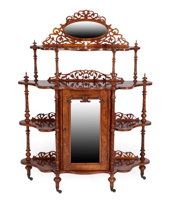 Lot 1434 - A Victorian Burr Walnut Whatnot, circa 1870, of graduated form with an oval moulded frame above...