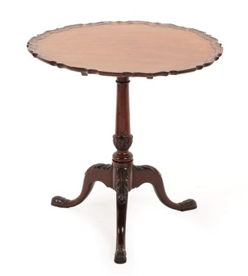 Lot 1440 - A George III Style Mahogany Pie Crust Tripod Table, the flip-top on a baluster acanthus carved...