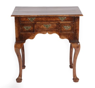 Lot 1453 - A Walnut and Feather Banded Dressing Table, the quarter-veneered top above a long frieze drawer...