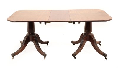 Lot 1466 - A George III Mahogany Twin-Pillar Dining Table, late 18th century, with one additional leaf and...