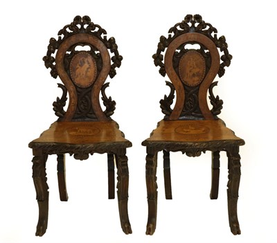 Lot 1482 - A Pair of Late 19th Century Tyrolean Carved Walnut Hall Chairs, with marquetry inlay and...