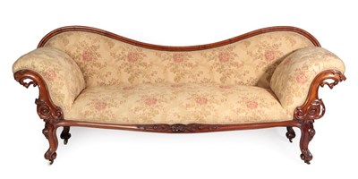 Lot 1492 - A Victorian Carved Mahogany Scroll End Sofa, circa 1870, recovered in floral fabric by Julia...