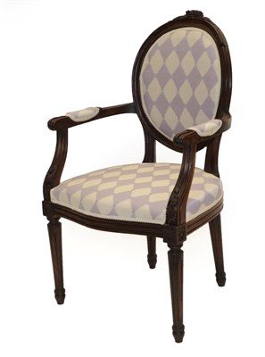 Lot 1507 - A Louis XVI Walnut Fauteuil, late 19th century, recovered in geometric silk damask, with padded...