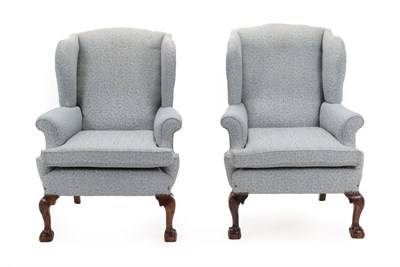 Lot 1518 - A Pair of Early 20th Century Wing-Back Chairs, in George III style, recovered in blue acanthus...