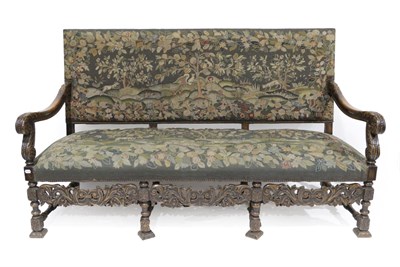 Lot 1519 - A Late 19th Century Carved Oak Three-Seater Sofa, in William & Mary style, covered in green...