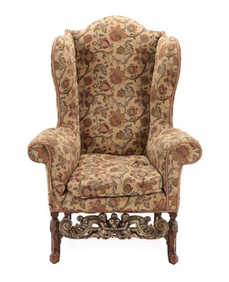 Lot 1520 - A William & Mary Style Wing-Back Armchair, late 19th/early 20th century, covered in crewel...