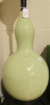 Lot 6 - A Chinese Celadon Ground Double Gourd Vase, late Qing Dynasty, mounted as an electric lamp...