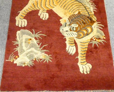 Lot 15 - Tibetan Tiger Rug Tibet or Nepal, circa 1950 The tiger in semi-naturalistic form beneath a...