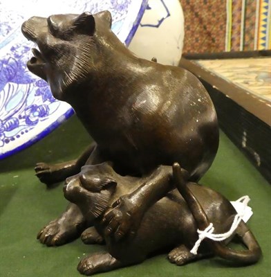 Lot 19 - A Japanese Bronze Figure of a Wild Cat, Meiji period, seated, a forepaw on her cub, three character