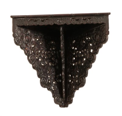 Lot 21 - A Chinese Hongmu Corner Wall Bracket, 19th century, with apron and triangular supports, carved...