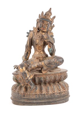 Lot 30 - A Gilt Bronze Figure of Tara, probably Tibet, 17th century, the seated figure with scroll headdress