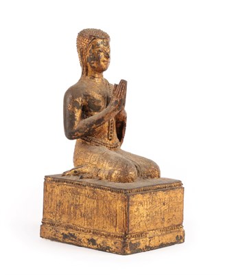 Lot 40 - A Gilt Metal Figure of Buddha, Thai, 19th century, the kneeling figure with hands at prayer, on...