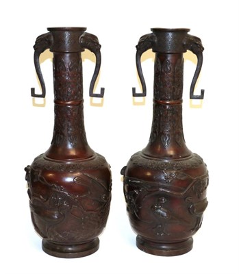 Lot 48 - A Pair of Japanese Bronze Bottle Vases, Meiji period, with mask and loop handles on stiff leaf cast