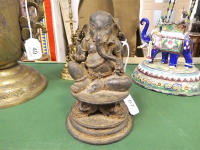 Lot 67 - An Indian Bronze Figure of Ganesha, probably 10th century, seated on a circular plinth supported by