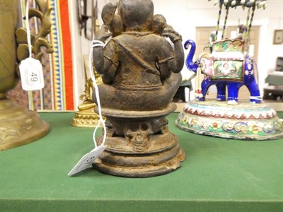 Lot 67 - An Indian Bronze Figure of Ganesha, probably 10th century, seated on a circular plinth supported by