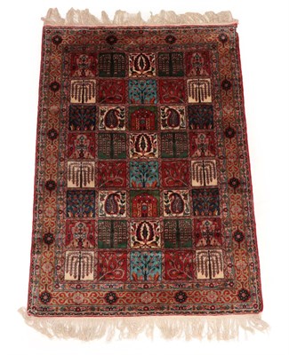 Lot 86 - Indian Rug, modern The compartmentalised field of trees and plants enclosed by narrow borders,...