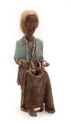 Lot 95 - An Indonesian Carved Wood Ancestor Figure (Tau-tau), modelled as a seated lady with shell necklace