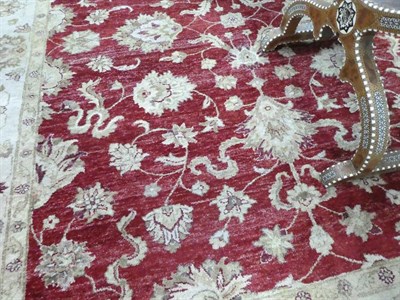 Lot 120 - Indian ''Ziegler'' Design Carpet, modern The abrashed claret field with an allover design of vines