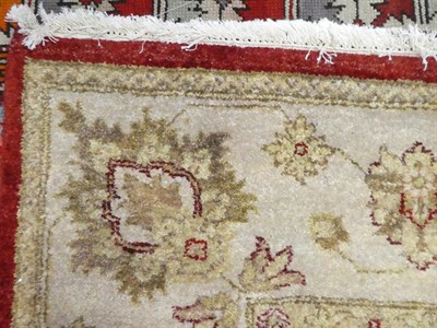Lot 120 - Indian ''Ziegler'' Design Carpet, modern The abrashed claret field with an allover design of vines