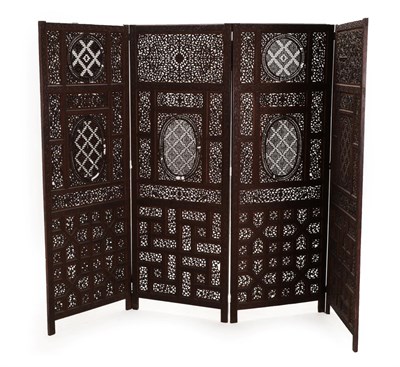 Lot 131 - An Indian Hardwood Four-Fold Screen, 19th century, carved and pierced with geometric and...