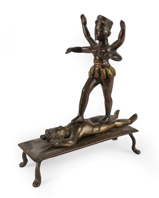 Lot 138 - An Indian Cold Painted and Gilt Figure Group, 19th century, modelled as Kali walking on Shiva, on a