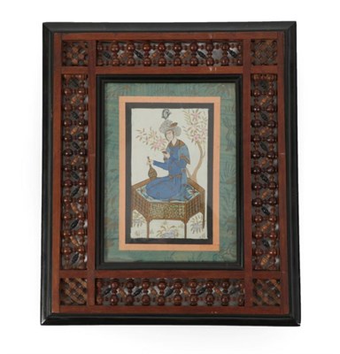 Lot 208 - Qajar School (late 19th/early 20th century) Portrait of a gentleman sitting on a low table, smoking