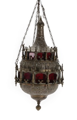 Lot 229 - A Qajar Stamped and Pierced Brass Hanging Lantern, late 19th century, of minaret form, with...