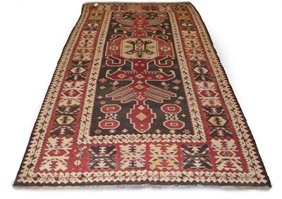 Lot 231 - Anatolian Kilim, late 19th/early 20th century The charcoal field with raspberry serrated...