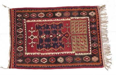 Lot 249 - Anatolian Kilim, 20th century The crimson field with central panel of hooked motifs and another...