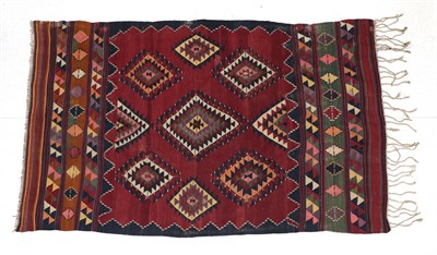 Lot 253 - Anatolian Kilim, circa 1950 The brick red field centred by a latch hook medallion surrounded by...