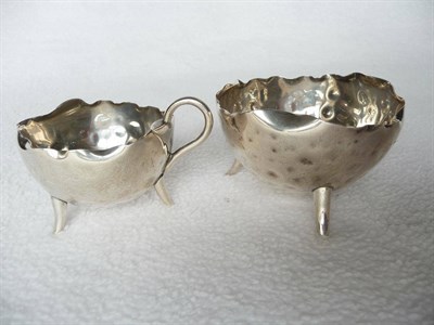 Lot 1467 - An Elkington Silver Milk Jug and Sugar Bowl, by Fredk. Elkington, Birmingham 1884, dimpled...