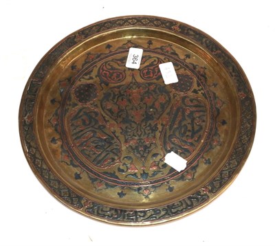 Lot 364 - A Cairo Ware White Metal and Copper Inlaid Tray, circa 1900, worked with arabesque and calligraphic