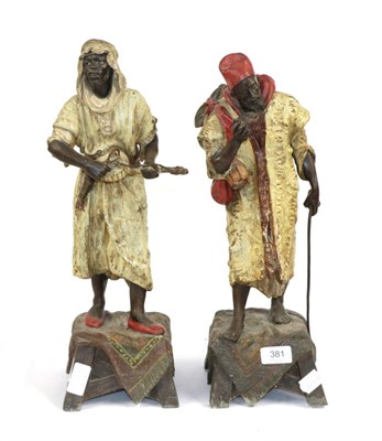 Lot 381 - A Pair of Austrian Cold Painted Spelter Arabesque Figures, circa 1900, as a street vendor holding a