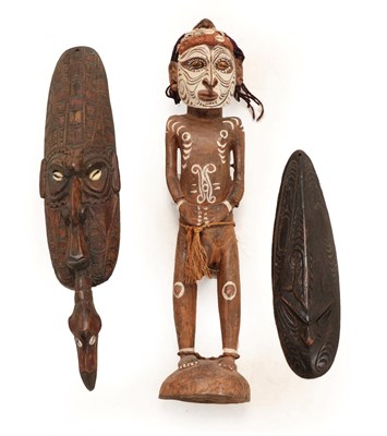 Lot 394 - A Papua New Guinea Ancester Figure, 57cm high, and Two Masks (3)